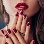 Beautiful woman with red lips and manicure