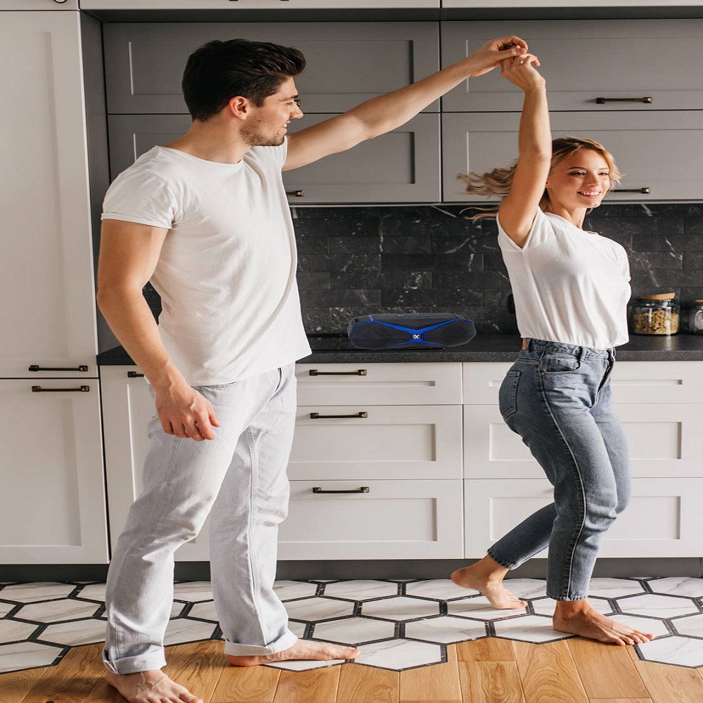Stylish girl in jeans dancing with husband in morning. Indoor photo of relaxed young people having fun in kitchen.